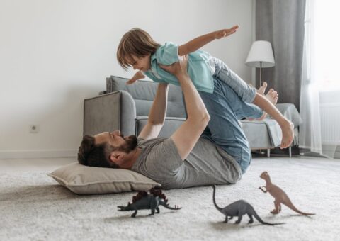 Father lifting a child, representing urgent parenting and relocation concerns