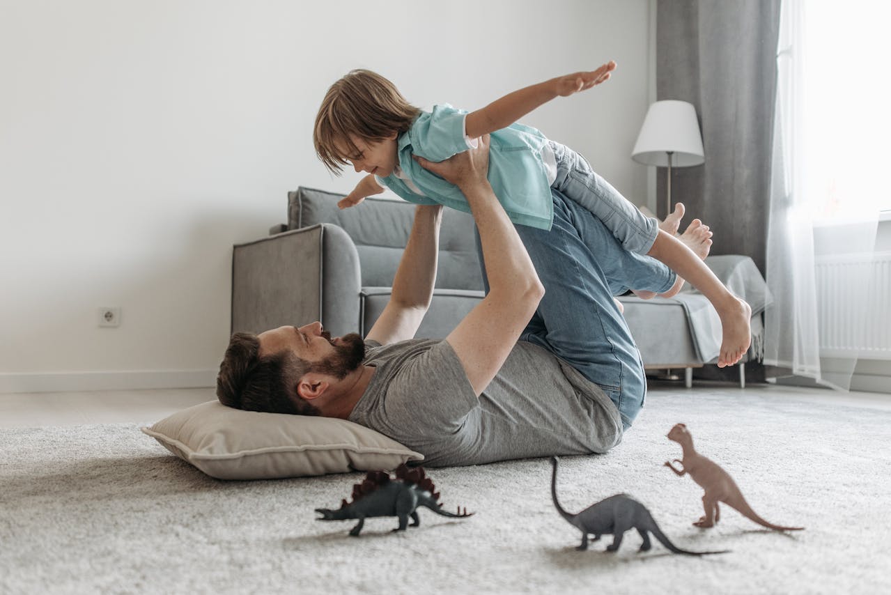 Father lifting a child, representing urgent parenting and relocation concerns